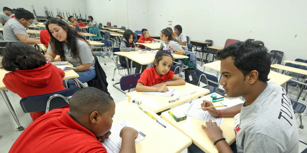 Bishop Scholars from Ohio Wesleyan tutoring students in a classroom at CBAN